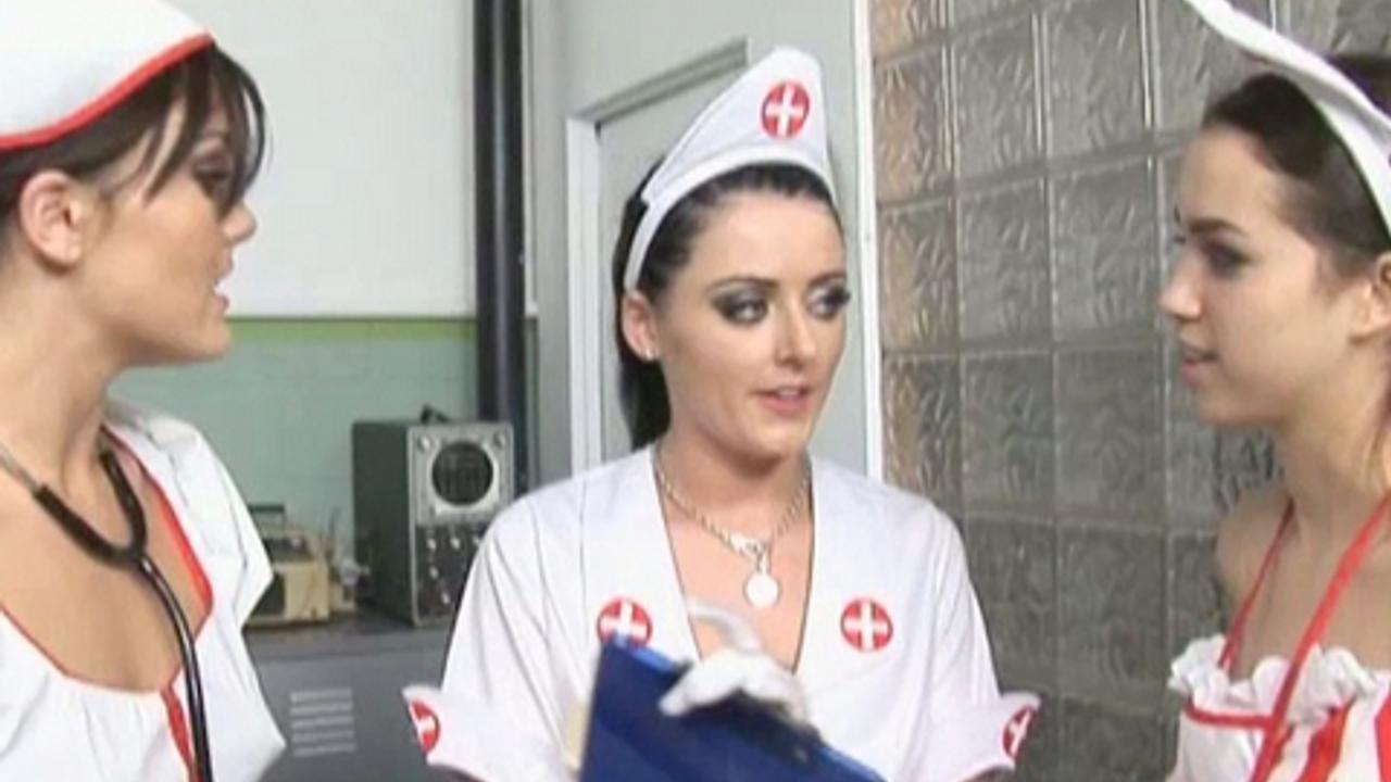 Three sexy naughty uniformed nurses jerk off a naked patient in cfnm style