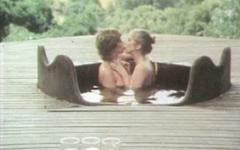 Two women share a guy and his cock in a hot tub on an outdoor deck join background