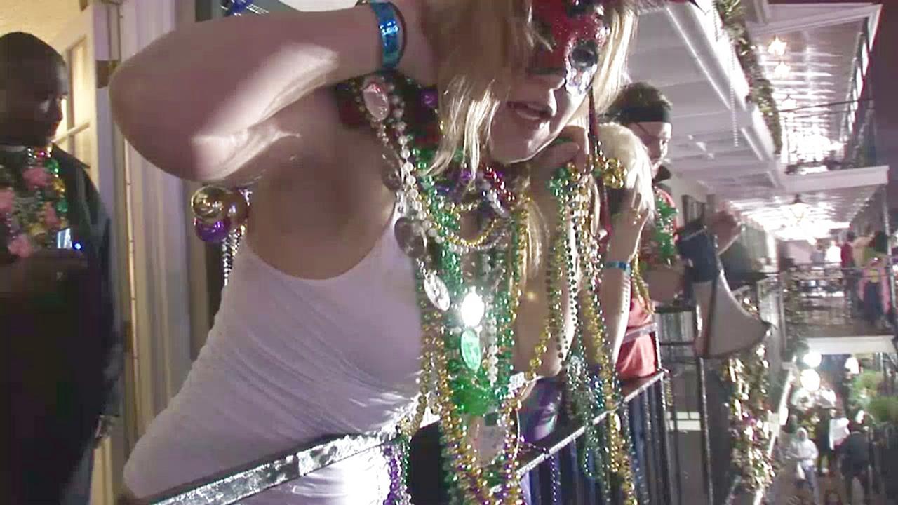 Frances tries to cover her nude boobs in mardi gras beads