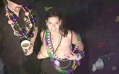 Christine wears many beads and rubs her breasts join background