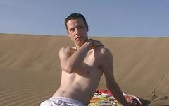 Sexy twink jock masturbates on a sand dune while sunbathing join background