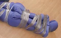 Completely encased female is bound with duct tape in BDSM bondage scene join background
