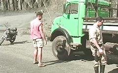 Muscle hunks have rough sex on a gravel road join background