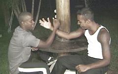 Armwrestling black jocks have anal sex outside at night.