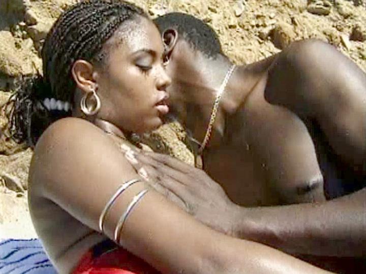 Horny black beauty takes a monster cock in the sand
