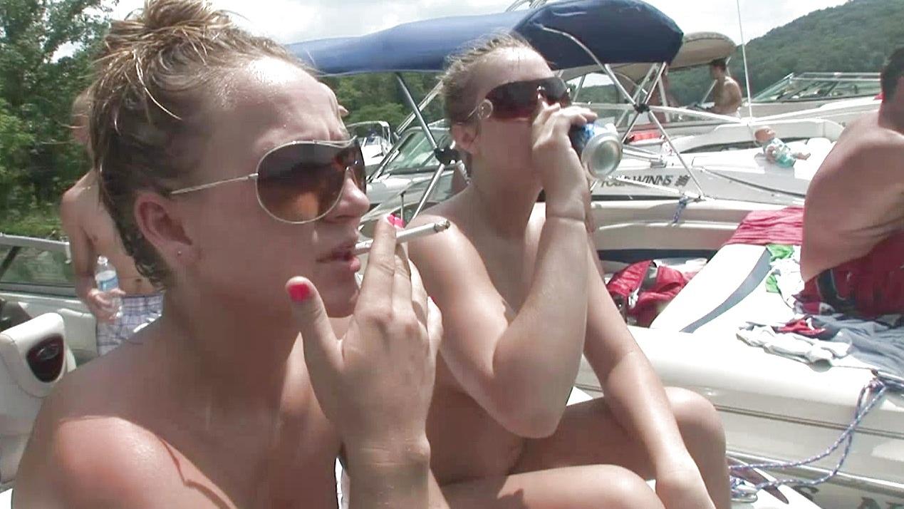 Topless coeds have some fun in the sun on a boat