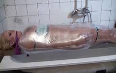 Angel Wicky is fully wrapped in plastic wrap which is filled with water - movie 3 - 2